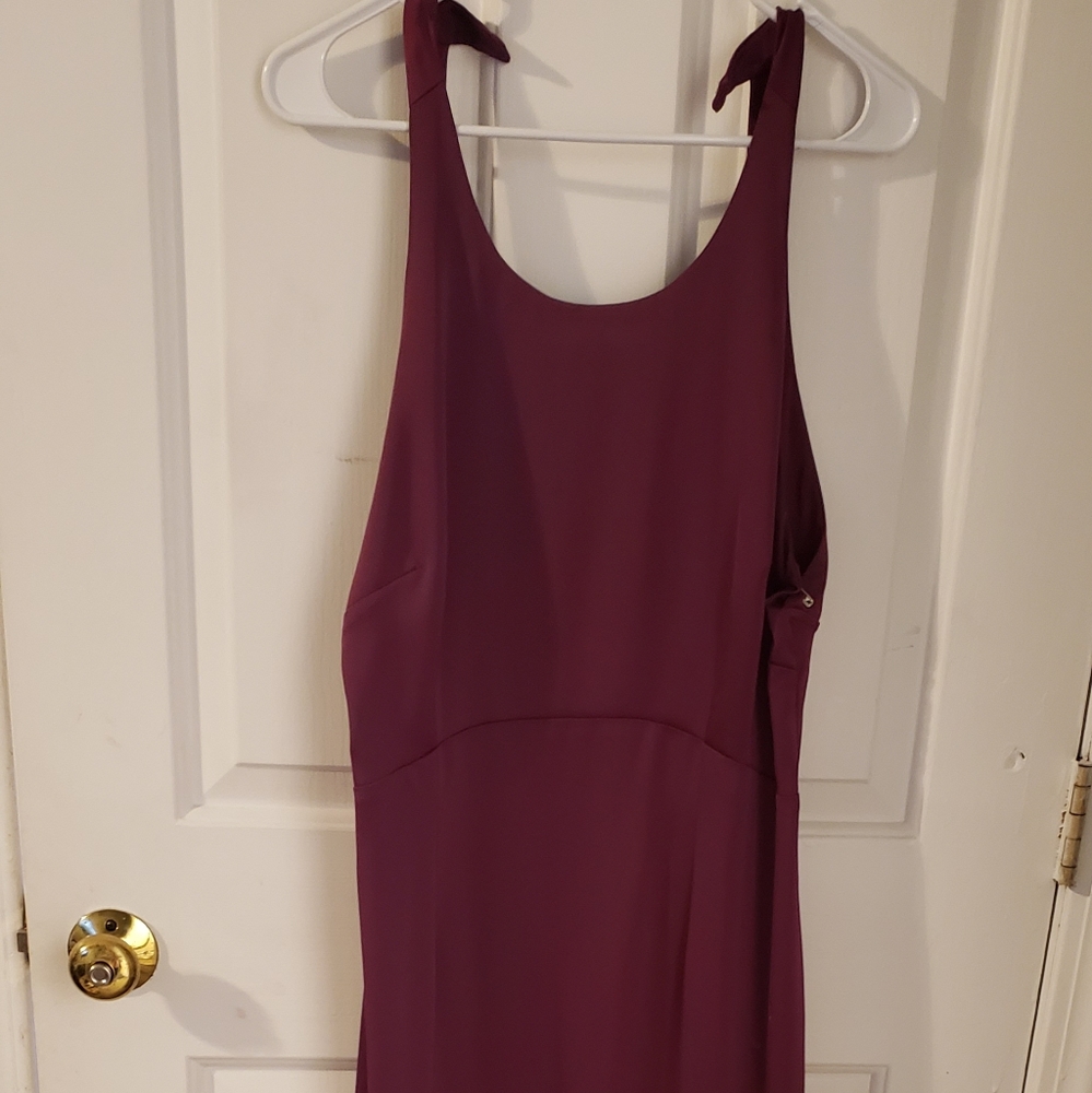 A beautiful purple dress that is low in the back.